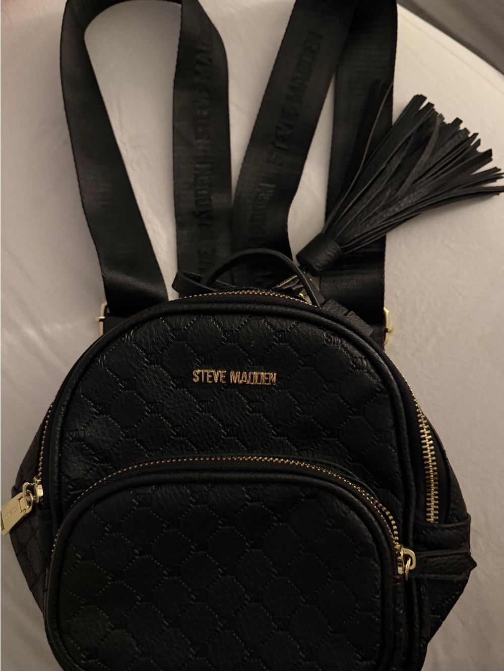 Steve Madden Black Embossed Logo Mini Backpack Gold Hardware Tassel